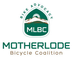 Green logo for Motherlode Bicycle Coalition, shows green highway sign shape with sun over mountains